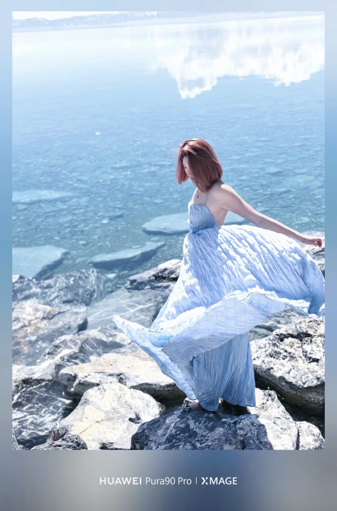 Hannah in a pale blue dress beside the clear water of Sayram Lake