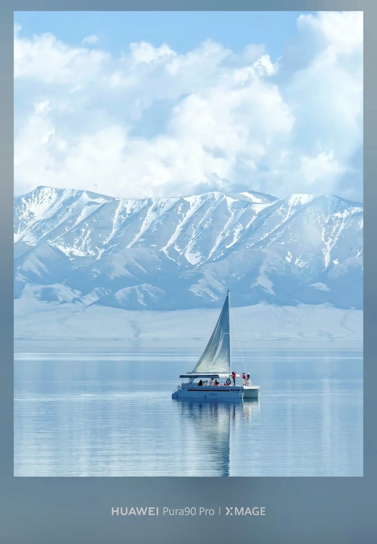 A small sailboat on Sayram Lake with snow mountains in the distance
